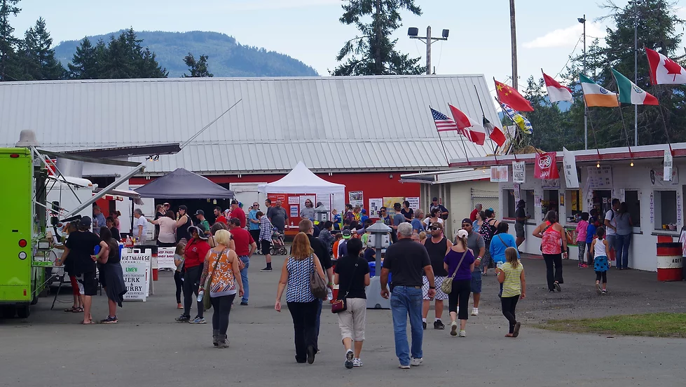 Visitors walking through food vendors and exhibits at the Alberni District Fall Fair in Port Alberni.