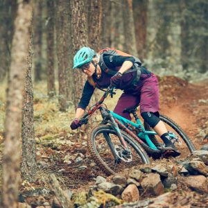 Woman mountain bike racing through Alberni Valley trails