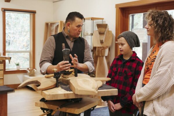 Gordon Dick demonstrates wood carving techniques to guests at his Ahtsik Gallery.