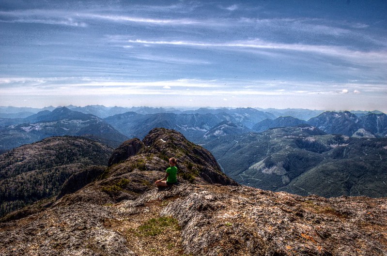 Woman looking out at the view from the top of Mt Arrowsmith, Alberni Valley