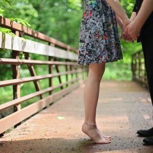 Couple Holding Hands on a bridge