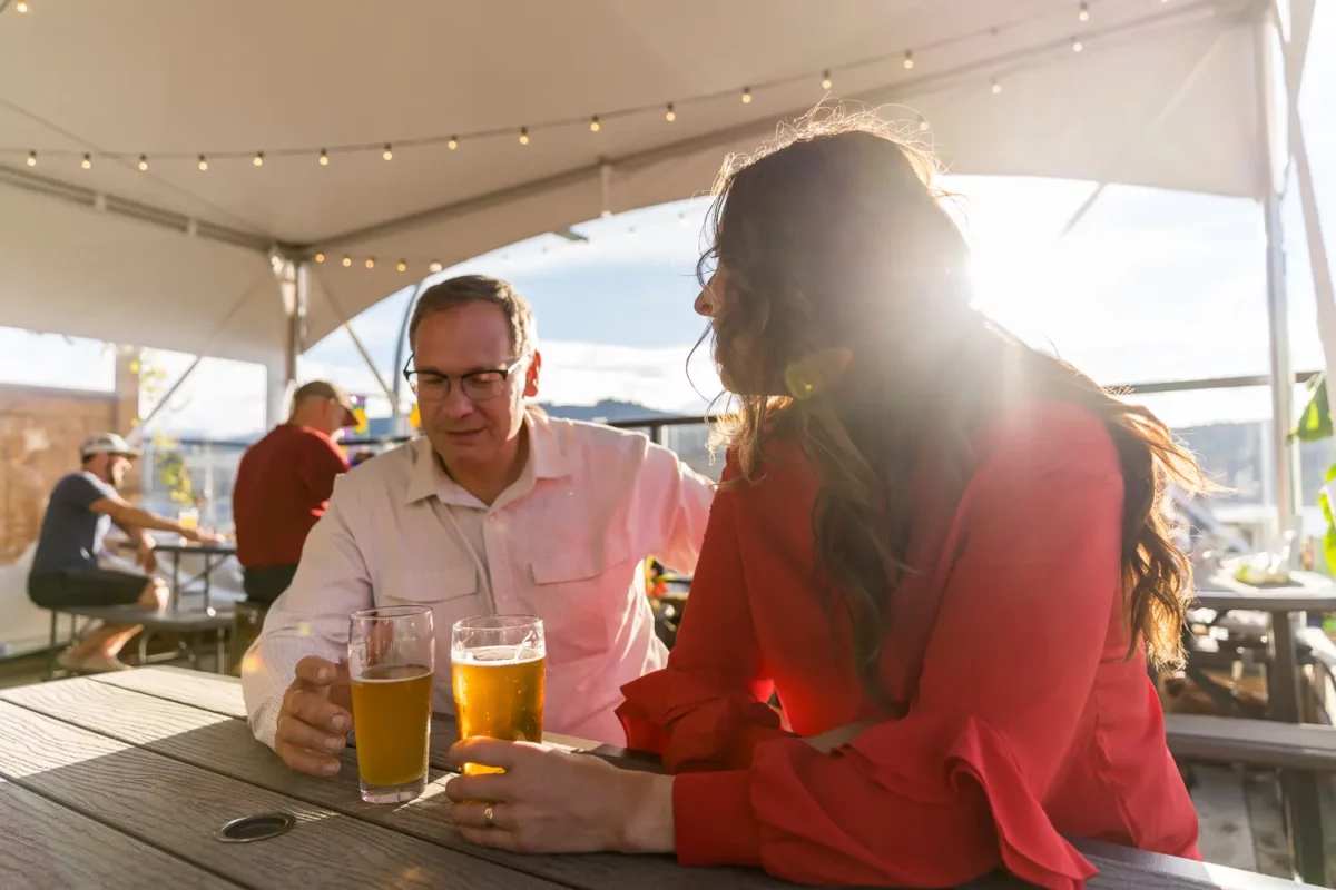 Couple enjoying drinks on an outdoor patio in downtown Port Alberni on a summer evening.