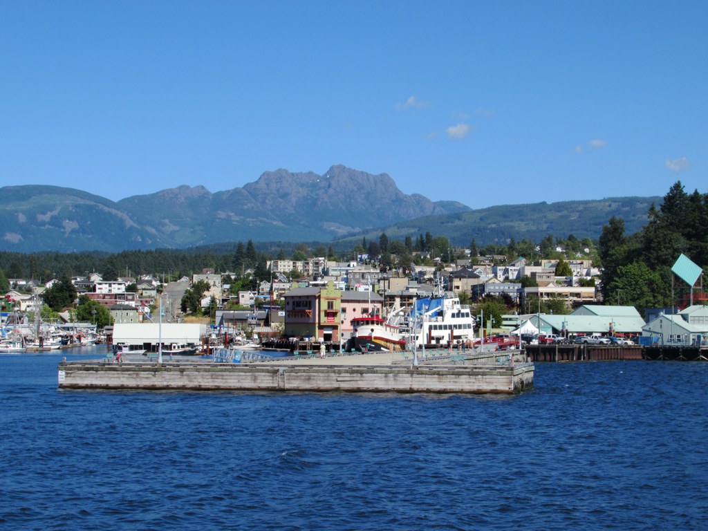 Harbour Quay from a distance, showing inlet, boats, and mountains