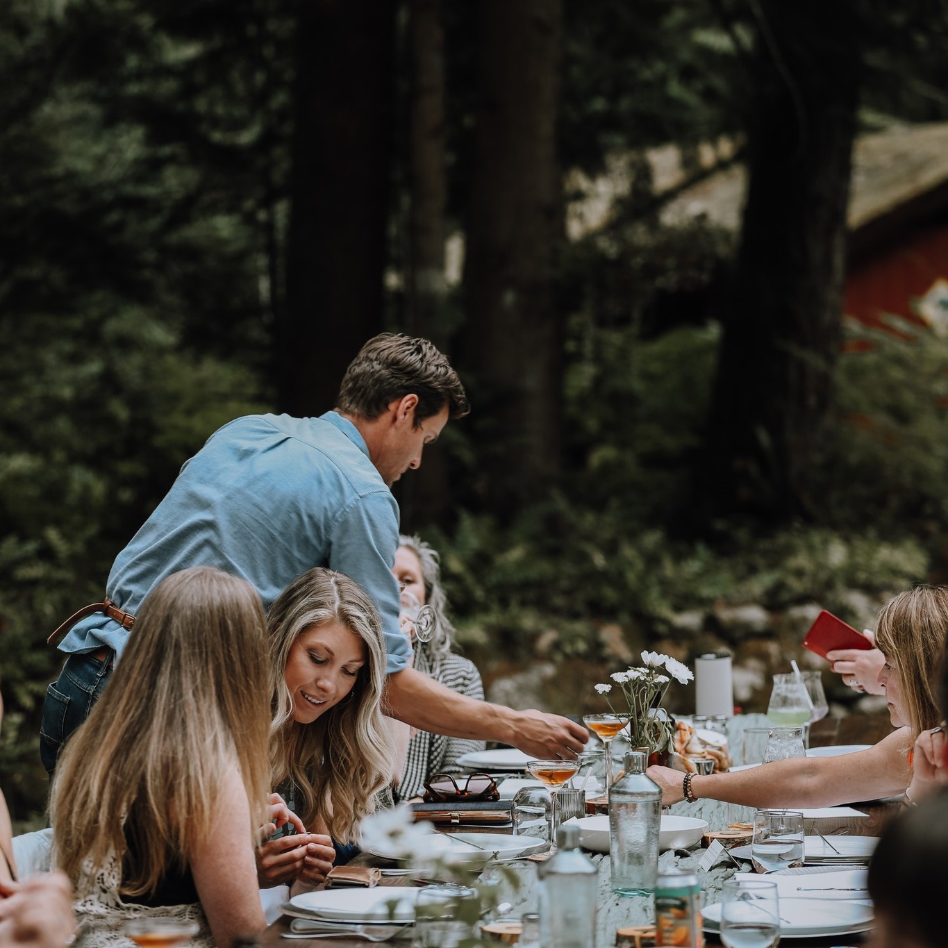 Waiter serving dinner at a special occasion at the Cabin at Shannon Farms in the Alberni Valley - the perfect summer date idea!