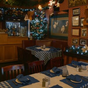 A cozy, holiday-decorated dining room with festive lights, traditional decor, and winter ambiance — evoking the warmth of Port Alberni’s local restaurants in colder months.
