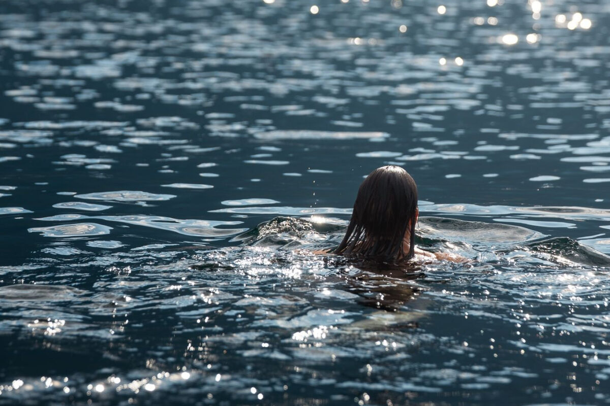 Swimming in clear water at Sproat Lake on a warm day