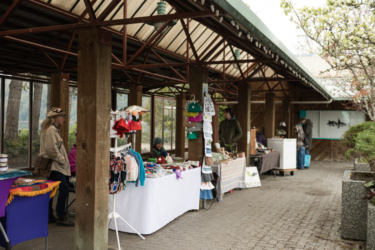Farmers market set up within the square, with vendor tables arranged in rows and clear pathways between stalls.
