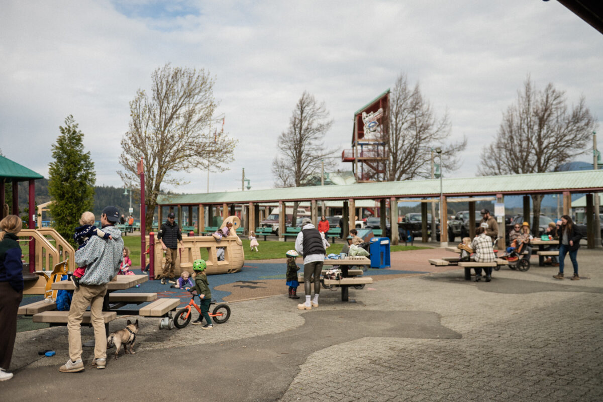 Wide public square at Harbour Quay with flat paved brick ground, open space, and permanent features like pillars and seating.
