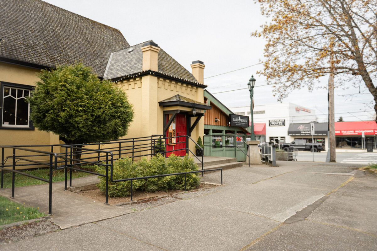Entry of restaurant has a ramp leading to the entrance and a manual door.
