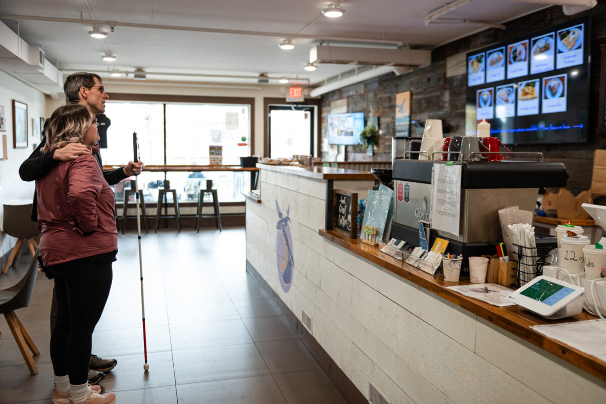 Open café interior with clear pathways, no rugs or carpets, and table and booth seating.