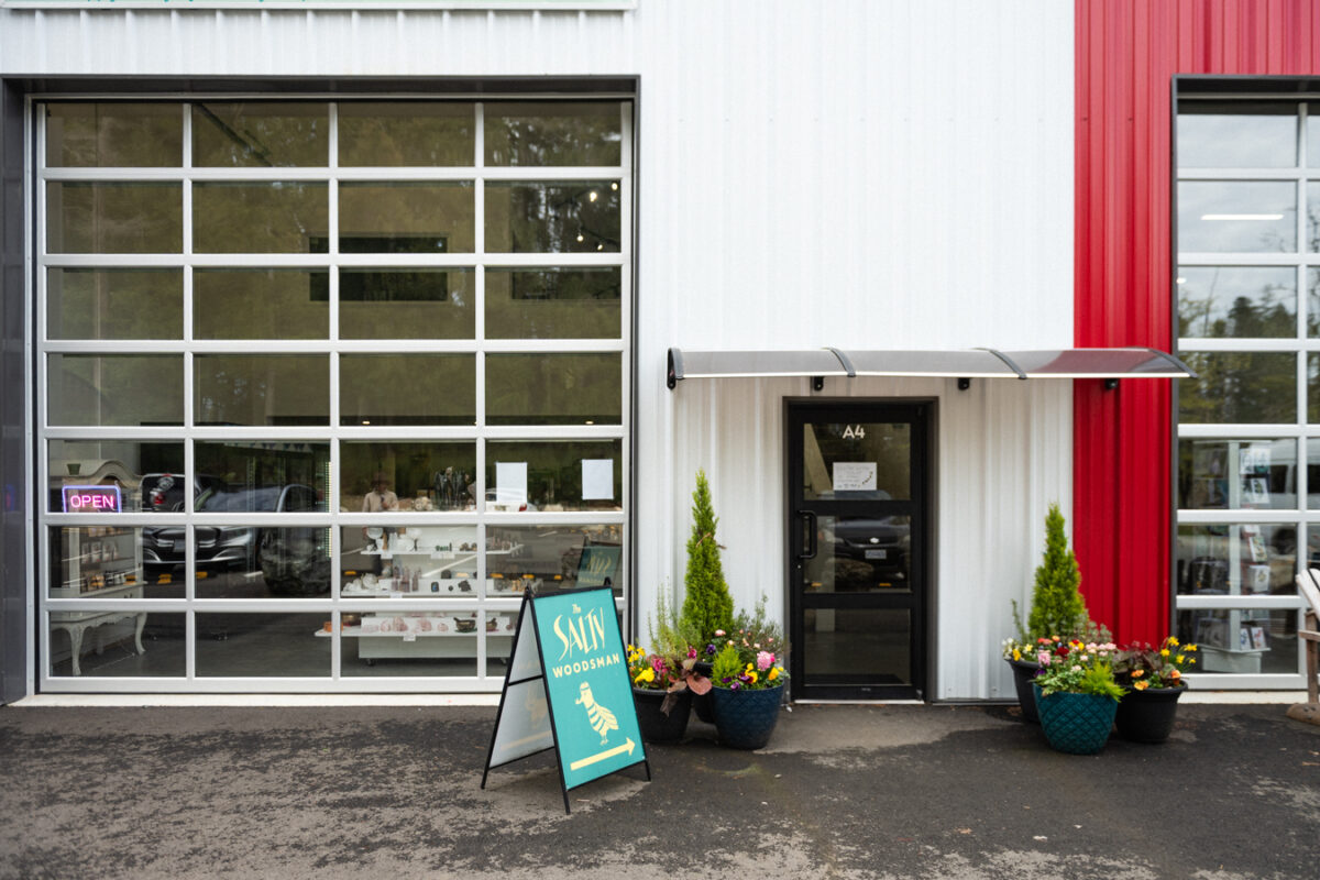 Exterior of a shop in an industrial area with a step-free entrance and manual door.