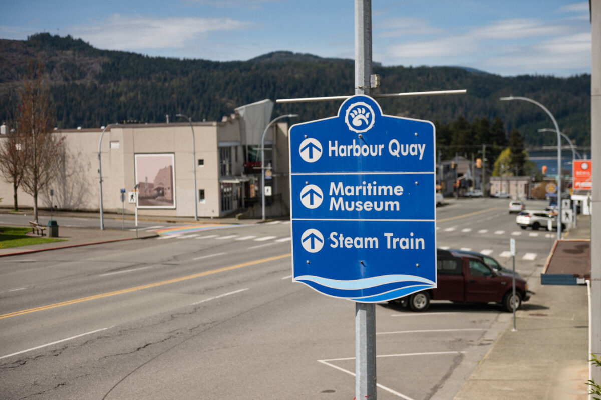 Signs with high-contrast colours, clear text and arrows showing routes to local areas.