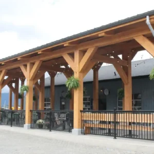 A wide scenic shot of the freshly renovated Harbour Quay waterfront in Port Alberni under a blue sky, showcasing new architectural details and vibrant community gathering spaces.