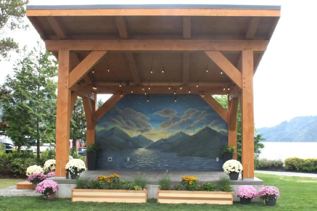 Close-up of the newly renovated park band shell at Harbour Quay, featuring a colorful custom painted mural by local artist Olesia Matsai.