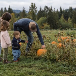 Family choosing pumpkins at Collins Farm at Arrowvale in the Alberni Valley