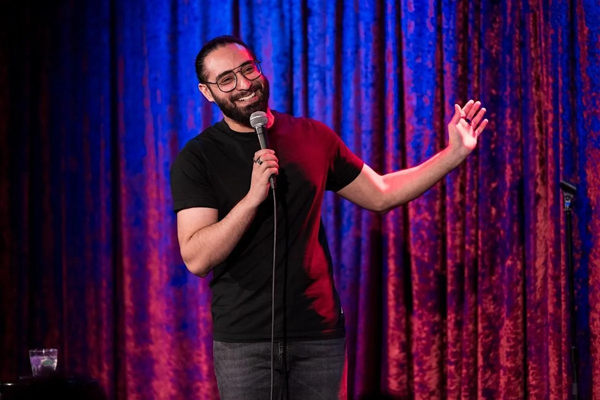 Ashwyn Singh performing stand-up comedy on stage