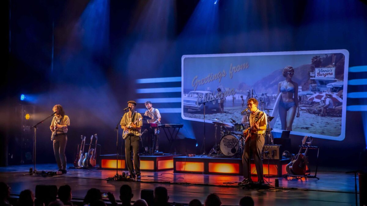 Musicians performing a Beach Boys tribute concert on stage